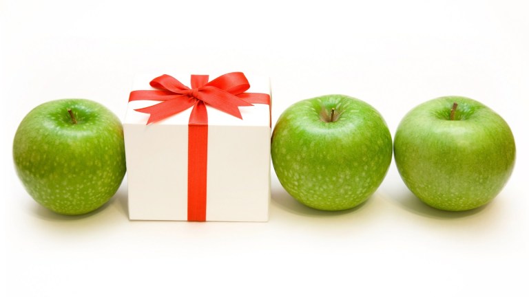 3 green apples and white gift box w red ribbon